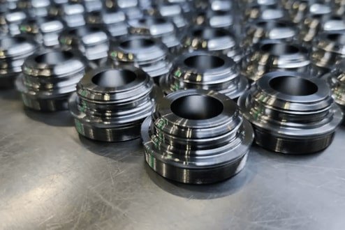 A batch of CNC-machined metal parts arranged for low-volume production.
