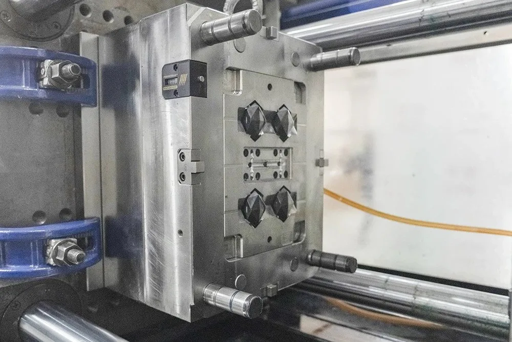 An Injection Molding Machine is Molding Parts