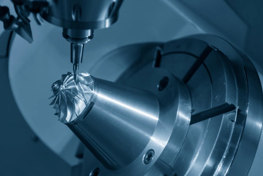 A complex metal component being machined using 5-axis CNC machining.
