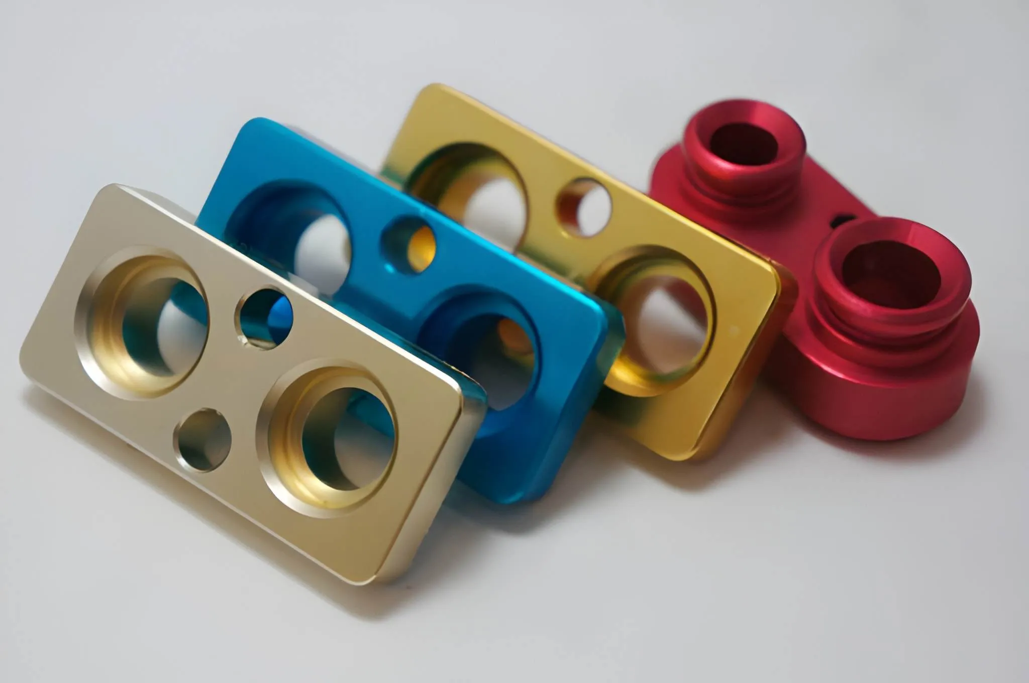 Anodized aluminum parts with multiple holes.