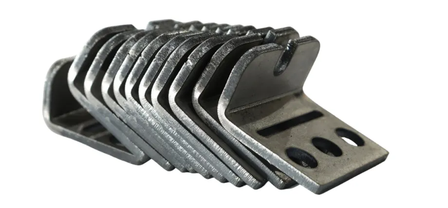 Metal products bent on a bending machine lie on a white background