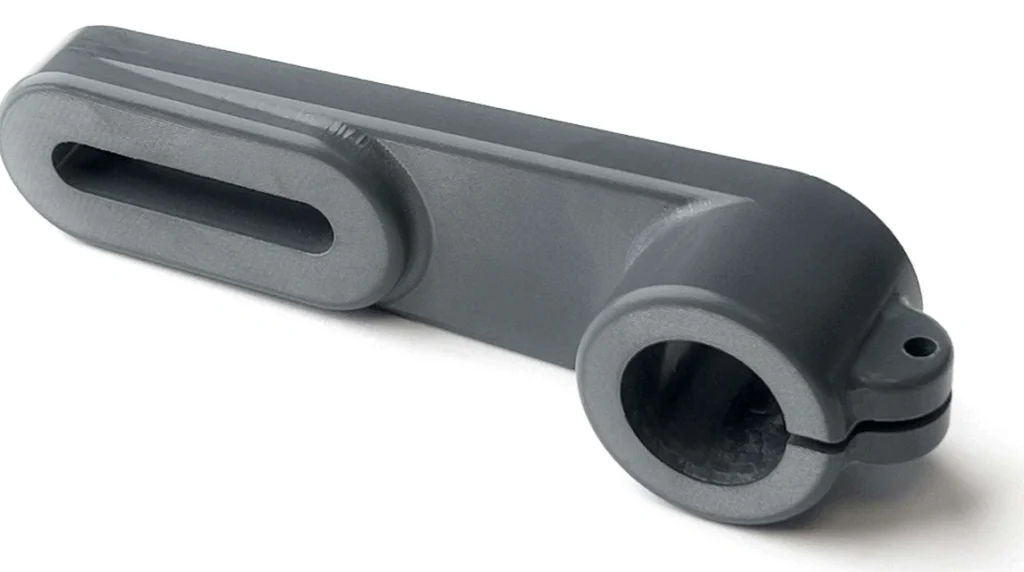 Black CNC-machined PVC part with circular and rectangular holes
