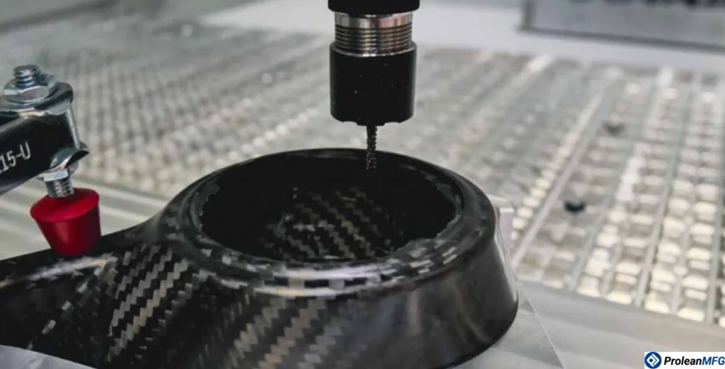CNC milling tool machining a circular composite part with visible black and grey grain texture