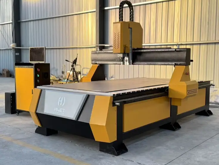 A yellow CNC router machine with a gantry-mounted spindle, engineered for carving patterns into large flat sheets of material