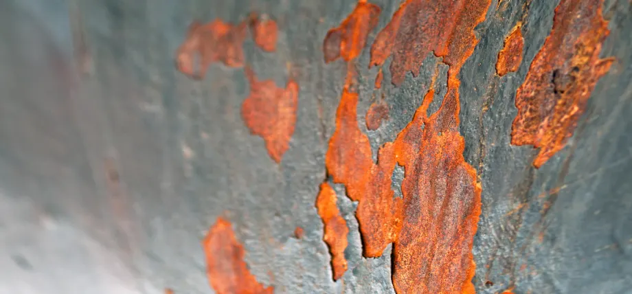 Corroding layers of stainless steel to reveal rusted orange parts
