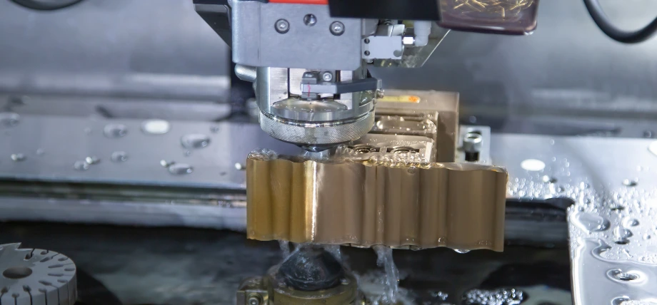 EDM wire cutting through a submerged part