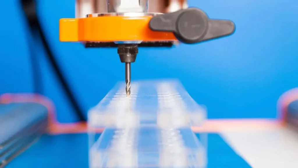 Close-up of drill bit working on transparent material.