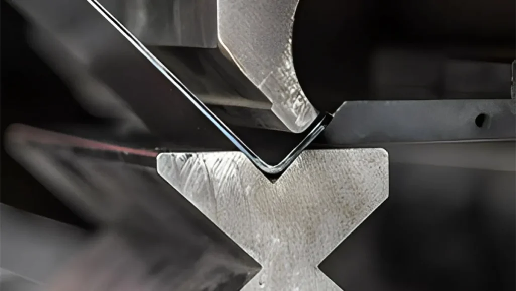 Metal sheet being bent into an angle.