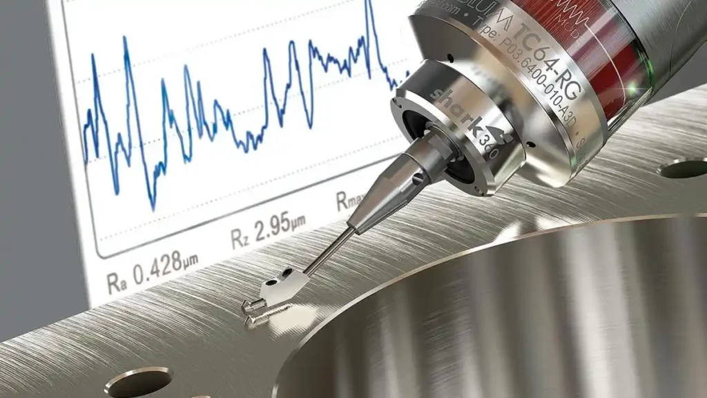 Surface roughness measurement tool on a metal part.