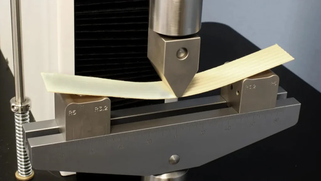 Material sample undergoing a three-point bend test.