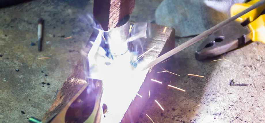 Welding sparks on a metal from an electrode