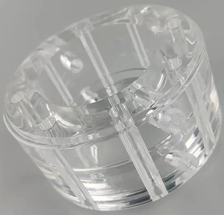 Transparent round polycarbonate CNC-machined part.
