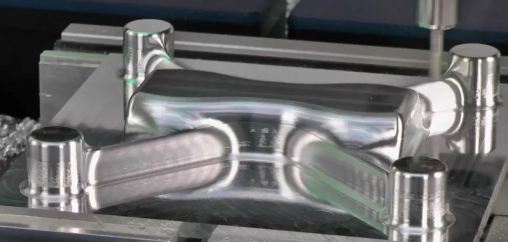 Shiny CNC-machined aluminum part with multiple features