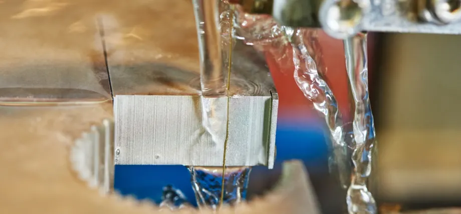 EDM wire under direlectric fluid; Close up of running dielectric fluid over an EDM wire
