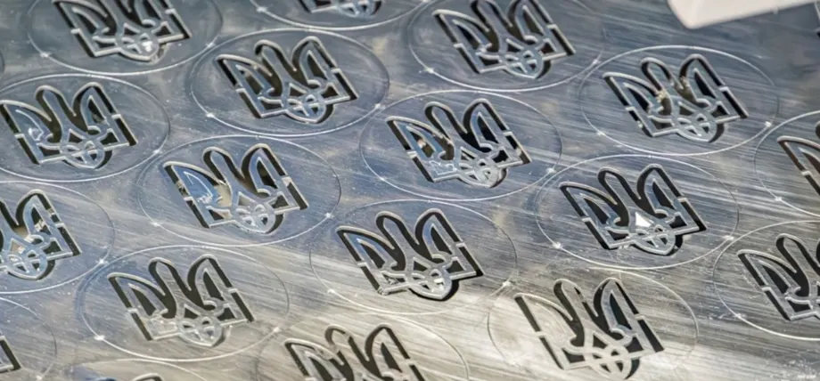 Close-up view of rows of circular metal stamps marked with D