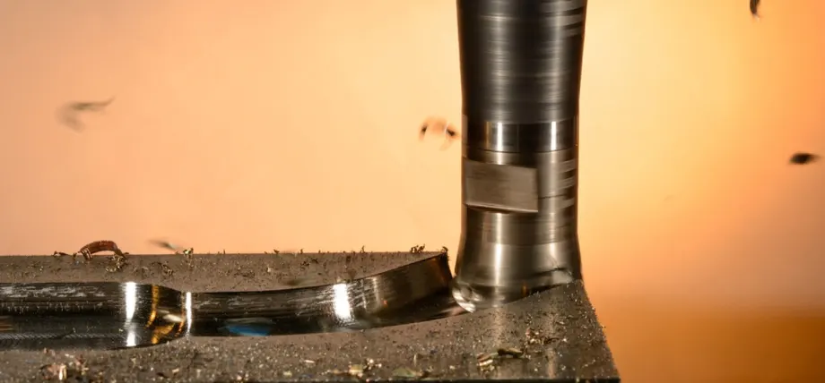 Milling cutter close up with metal chips flying