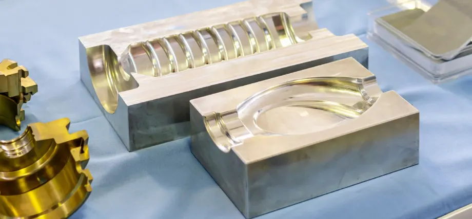 Two part steel mold on a blue cloth