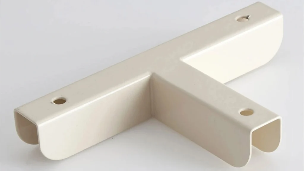 Beige T-shaped bracket with rounded ends and holes.