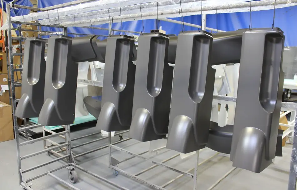 Large thermoformed automotive interior panels with complex curved geometries on the production assembly line cooling section