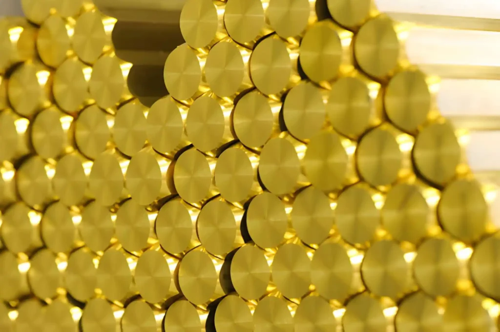 lose up on ends of newly manufactured shiny brass rods in a neatly arranged stack