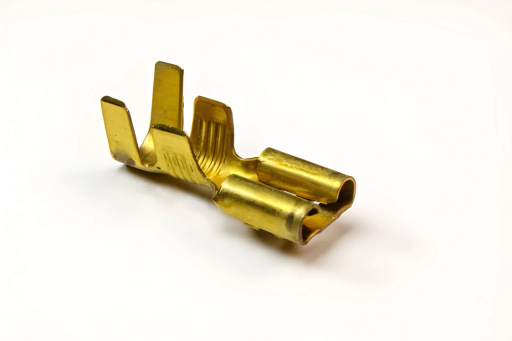 A close-up view of a brass automotive connector.