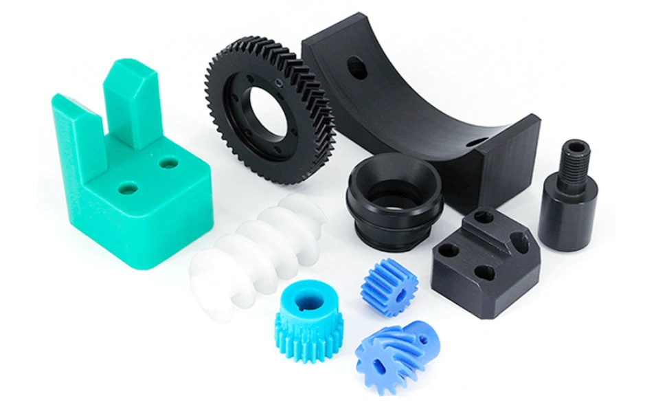 Assortment of CNC-machined plastic parts, including gears, brackets, and components in various colors