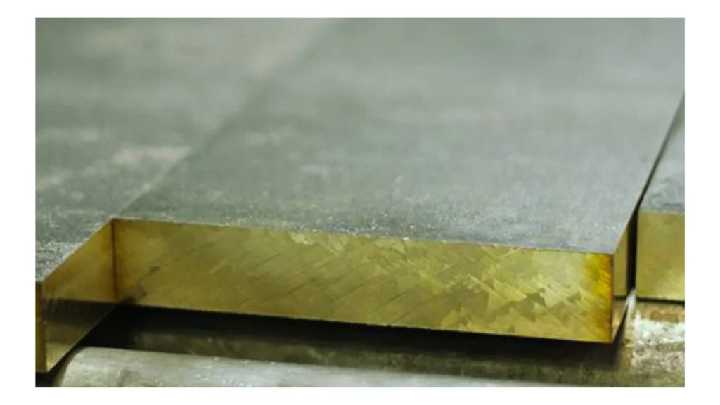 A sheet of navel brass with cut corners.