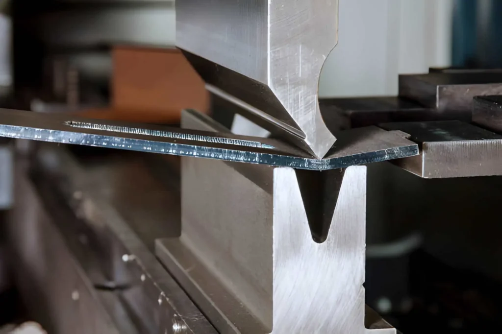 The image showing bending sheet metal on a hydraulic machine.
