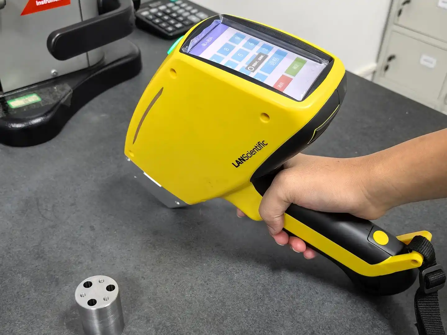 Handheld spectrometer used to verify metal material composition during incoming inspection and quality control in a manufacturing environment.