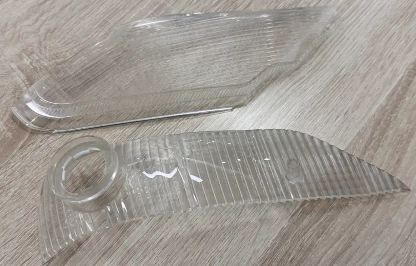 CNC-machined transparent acrylic parts showing precision tooling marks and curved designs