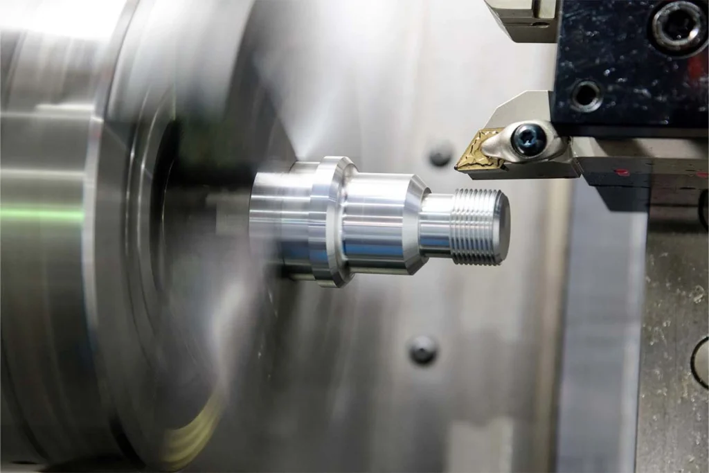 A thread cutter creating an external thread in a CNC lathe 