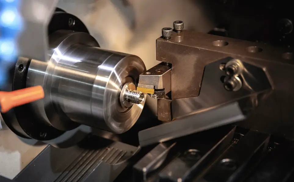 CNC lathe turning a precision metal aerospace component with a carbide cutting tool 