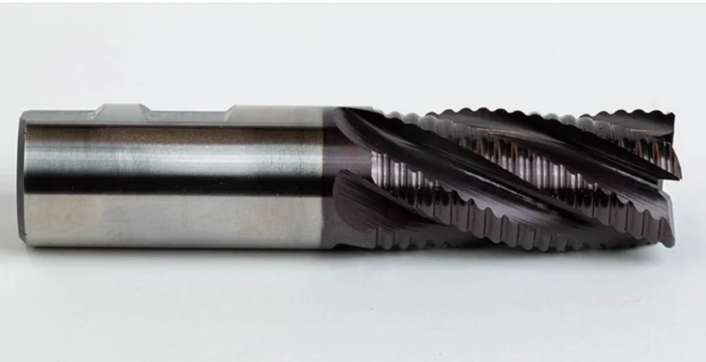Close-up of a multi-flute roughing end mill with serrated cutting edges and dark TiAlN coating.