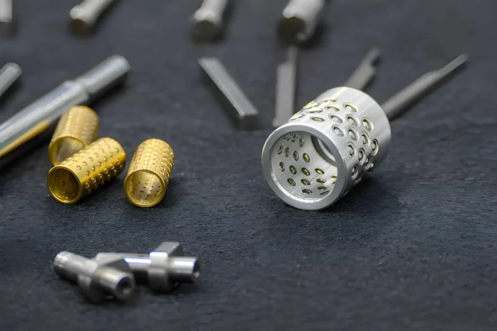 The image shows various Swiss-machined ball bushing components arranged for display. The parts are cylindrical, with features such as grooves, holes, and smooth-machined surfaces.