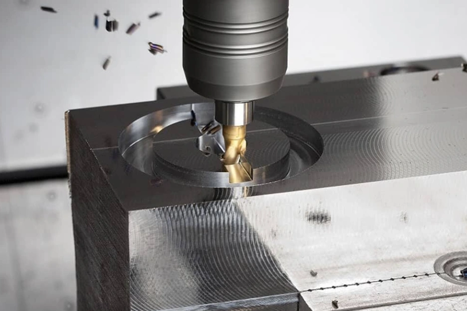 Indexable milling cutter performing steel machining and precision metal machining operations on a stainless steel block with metal chips flying