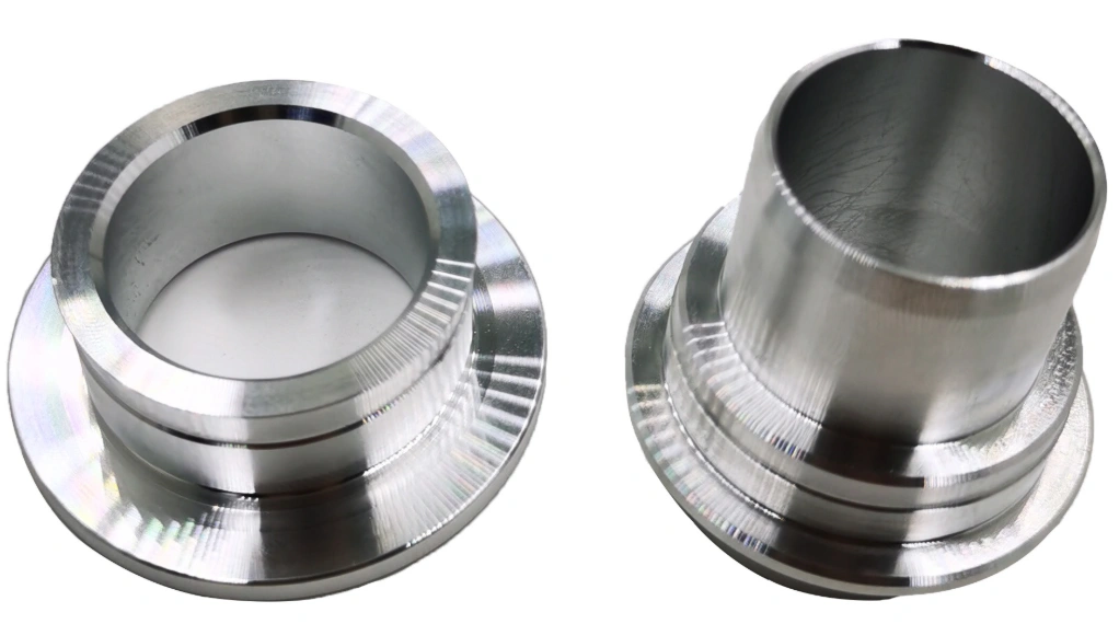 Two CNC-turned 6082 aluminum flanged sleeve parts showing precise lathe toolpath marks on polished surfaces