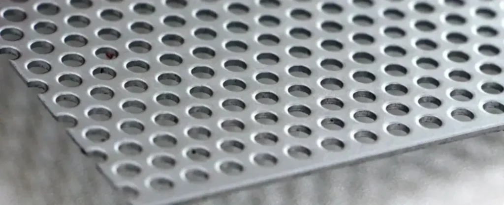 Laser-cut 310 stainless steel sheet with uniform grid of circular perforations