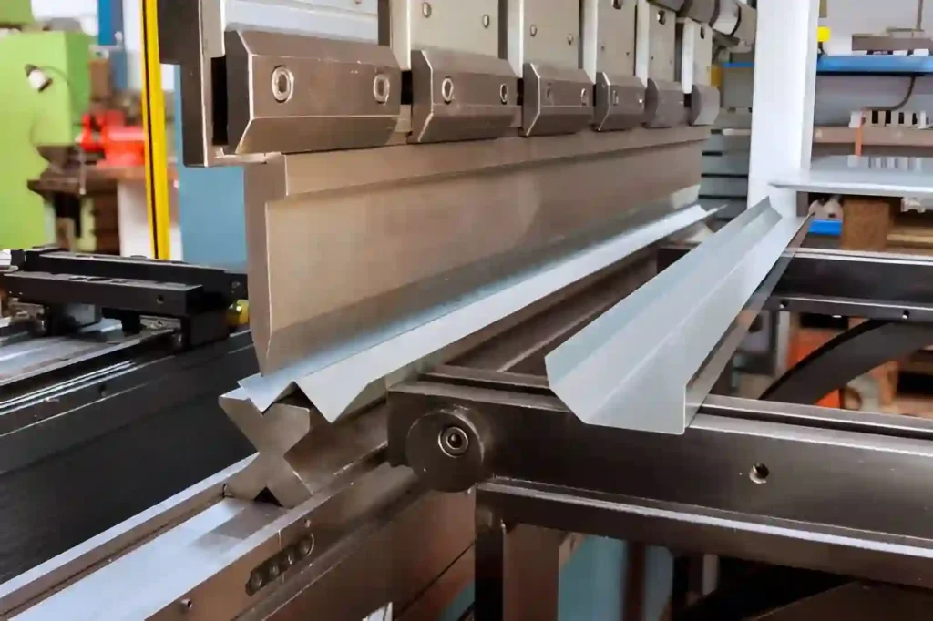 The image shows an aluminum sheet being bent using a hydraulic press brake machine.