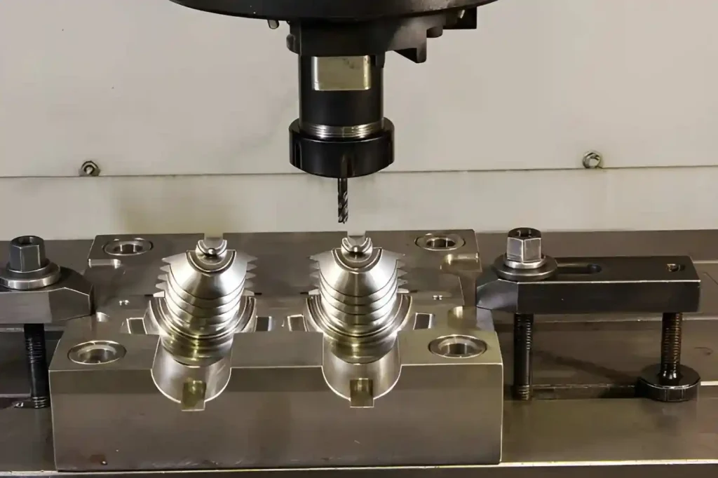 The image shows rapid tooling components being machined on a CNC machining center.