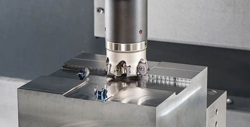 CNC machine milling a stainless steel workpiece