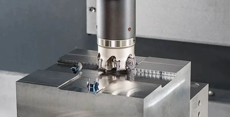 CNC machine milling a stainless steel workpiece
