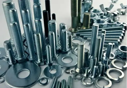 Assorted alloy steel fasteners, including bolts, nuts, washers, and screws of various sizes, arranged together
