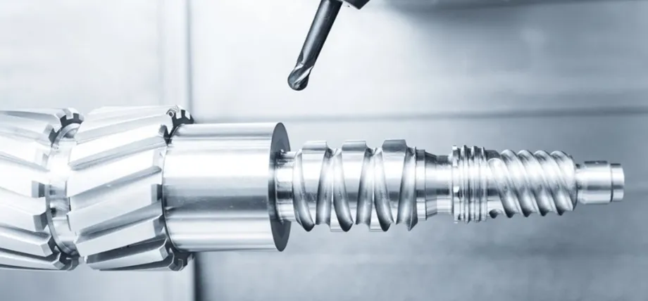 4-axis CNC milling machine, precision-machining a complex threaded shaft with helical features, showing simultaneous rotary table rotation