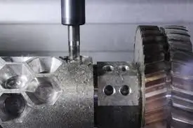 Close-up of a CNC machine cutting threads into a metal part beside a large gear during a precision machining process.
