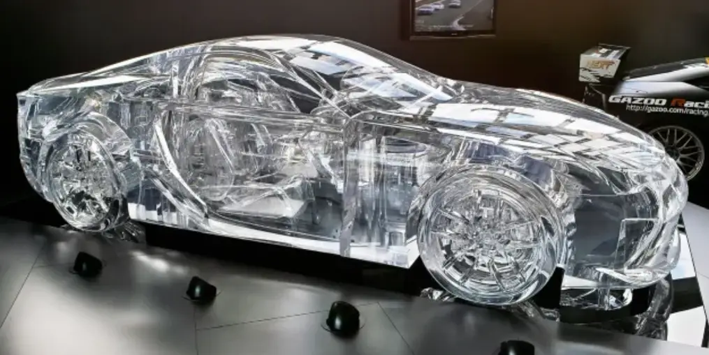 Full-scale transparent PMMA acrylic prototype of a car body revealing detailed interior and mechanical components