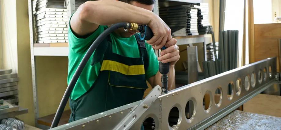 using a pneumatic drill to fasten or assemble a long aluminum extrusion profile with multiple circular holes