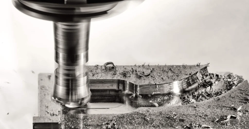 An image with a close-up of a CNC milling tool working on aluminum