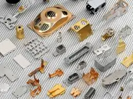 Assorted precision metal stamped parts in various shapes and finishes.