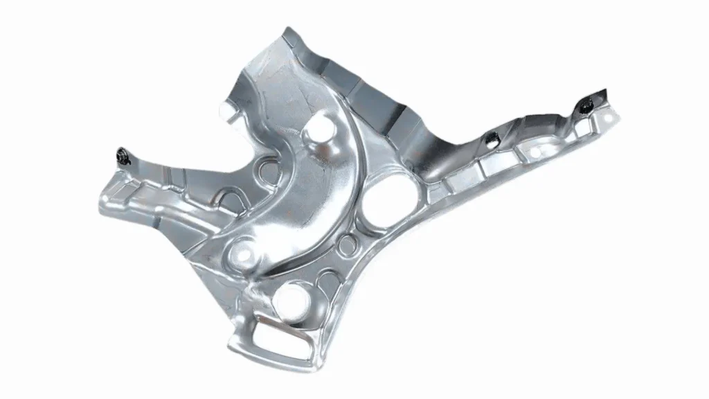 The image shows a close-up of stamped automotive metal parts used in vehicle manufacturing. 