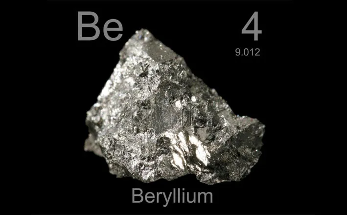Raw beryllium metal sample with atomic number 4 and atomic weight 9.012, which is one of the lightest metals used in aerospace manufacturing